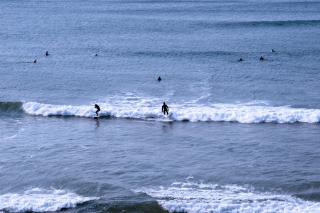 beautiful clean atlantic ocean with surfers catching the waves on Irelands coastの写真素材
