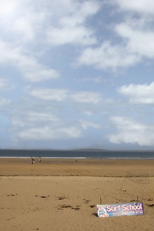 sandy beach with children getting ready to be taught surfing in ballybunion county Kerry Ireland in black and whiteのeditorial素材
