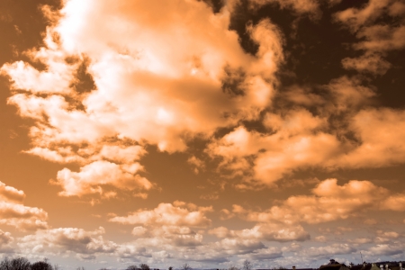 red cloudy sky in Ireland above trees, mountains and rooftopsの写真素材