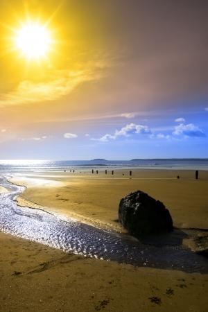 Beautiful yellow sun over the Youghal beach in Ireland on a summers dayの写真素材
