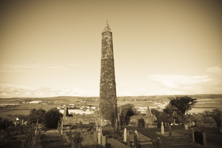 Ancient round tower and celtic graveyard with cathedral in Ardmore county Waterford, Ireland 