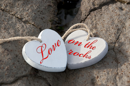 two wooden love hearts on the sand banks of an Irish beach in county Kerryの写真素材