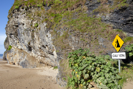 beware of cliff falls warning sign beside the cliffs in Ballybunion county Kerry Irelandの写真素材