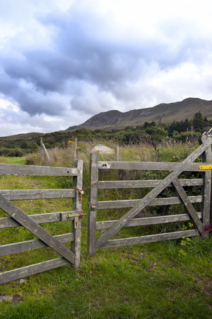 chained gate with mountains in the backgroundの写真素材