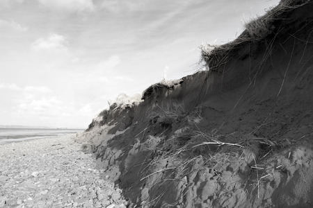 dunes that have suffered extreme coastal erosion damage due to big storm wavesの写真素材