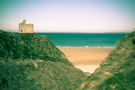 a beautiful fenced path to Ballybunion beach and castle in duotoneの写真素材