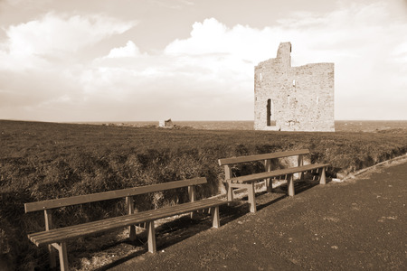 a beautiful path with benches to view Ballybunion beach and castle in sepiaの写真素材