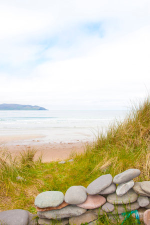 stone wall shelter on a beautiful beach in the maharees county Kerry Irelandの写真素材