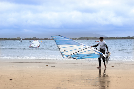 windsurfing champion getting ready to race and surf on the beach in the maharees county kerry irelandのeditorial素材
