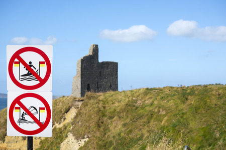 warning signs for surfers at ballybunion castle on the wild atlantic way in irelandのeditorial素材