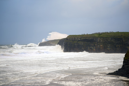 storm waves and cliffs on the wild atlantic way in Ballybunion county Kerry Irelandの写真素材