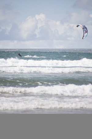 kite surfer on beautiful waves at beach in ballybunion county kerry ireland on the wild atlantic wayの写真素材