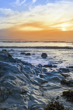 reflections at rocky beach near ballybunion on the wild atlantic way ireland with a beautiful yellow sunsetの写真素材