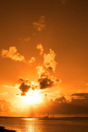 orange sunset over a power station on the river shannon in irelandの写真素材