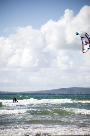 kite surfer on beautiful waves at beach in ballybunion county kerry ireland on the wild atlantic wayの写真素材