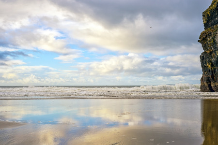 wet sand and cliff reflections on the wild atlantic way in Ballybunion Irelandの写真素材