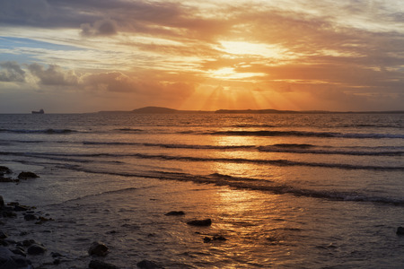 tanker in the shannon estuary near ballybunion on the wild atlantic way ireland with an orange sunsetの写真素材
