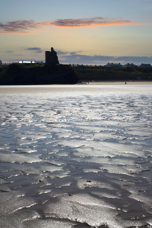 view of castle and rippled beach on the wild atlantic wayの写真素材
