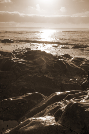 beautiful soft waves break on the rocks on sunset ballybunion beach in irelandの写真素材
