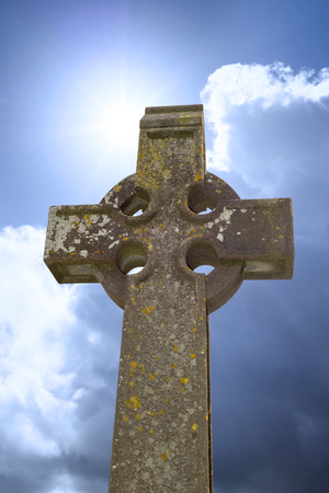 sunshine over celtic cross at ancient graveyard in St Caniceâ??s Cathedral in kilkenny city irelandの写真素材