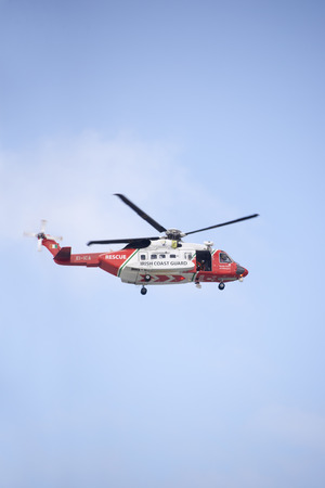 irish coastguard rescue helicopter on search mission in the irish skyの写真素材
