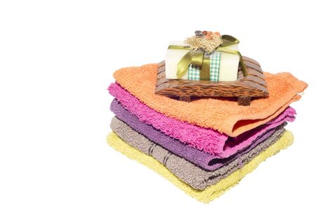 soap and dish on top of facecloths of various shadesの写真素材