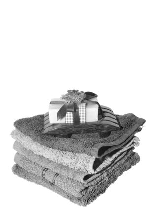 soap and dish on top of facecloths of various shadesの写真素材