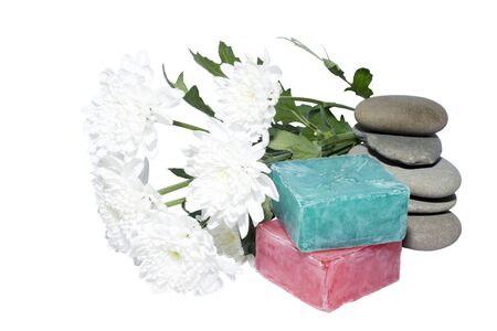 soaps off various shades with grey sone pebbles and flowersの写真素材
