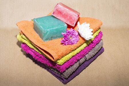 soap bar on top of facecloths off various shades with flowersの写真素材