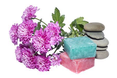 soaps off various shades with grey sone pebbles and flowersの写真素材