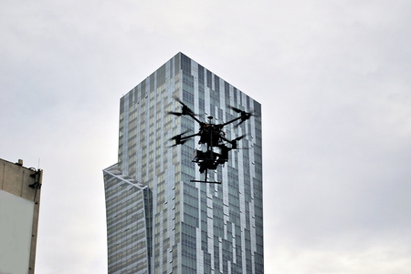 Drone silhouette flying above cityの写真素材