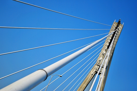 Modern bridge pylon against a blue sky