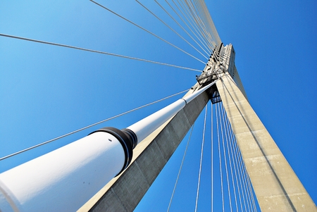 Modern bridge pylon against a blue skyの写真素材