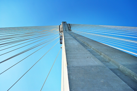 Modern bridge pylon against a blue skyの写真素材