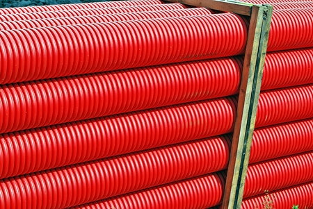 Red plastic tubes in the warehouse.の写真素材