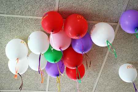 Warsaw, Poland. 10 June 2017. Interior of McDonald's restaurant. Many bright balloons under the ceiling close-upのeditorial素材