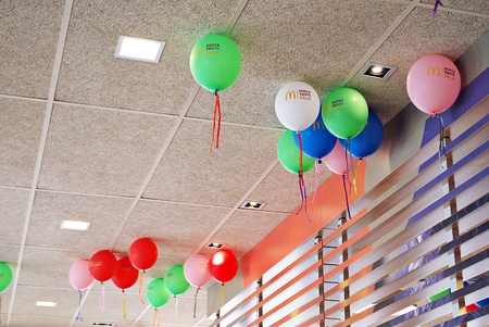 Warsaw, Poland. 10 June 2017. Interior of McDonald's restaurant. Many bright balloons under the ceiling close-upのeditorial素材