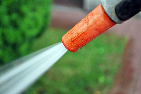 Spraying water from a garden hose