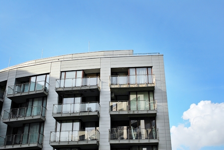 Modern apartment buildings on a sunny day with a blue sky. Facade of a modern apartment building