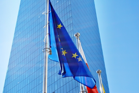European Union flags, flying and waving with glass