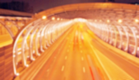 blurred traffic light trails on the road at nightの写真素材