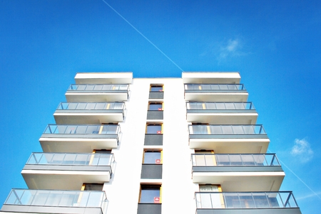 Modern apartment buildings on a sunny day with a blue sky. Facade of a modern apartment building