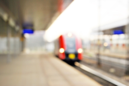 Blurred, bright shot of the urban train about to stop at the station platform