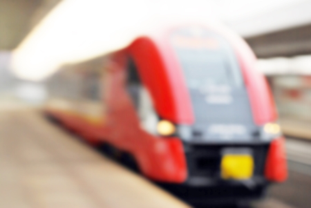 Blurred, bright shot of the urban train about to stop at the station platformの写真素材