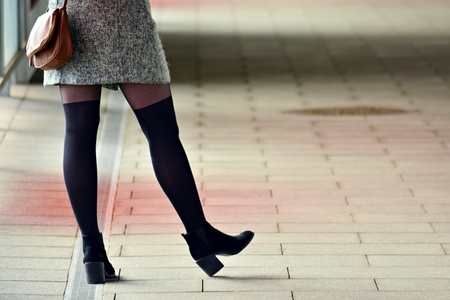 Woman's legs in high heels. Urban background.の写真素材