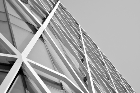 Modern office building wall made of steel and glass. Black and white.