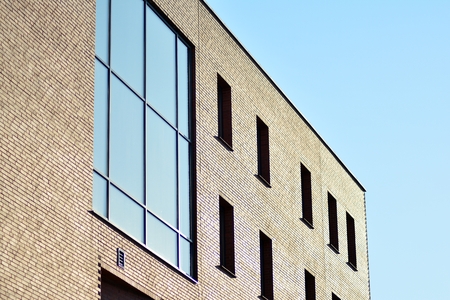 Beautiful facade of a modern office building made of red brick.の写真素材