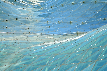 Urban abstract background, detail of modern glass facade, office business building.