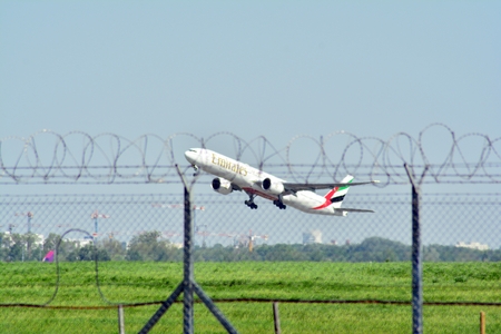 Warsaw, Poland.4 May 2018. Passenger airplane Boeing 777-300 ER Emirates Airlines is flying from the Warsaw Chopin Airport runwayのeditorial素材