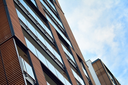 Modern apartment buildings on a sunny day with a blue sky. Facade of a modern apartment building